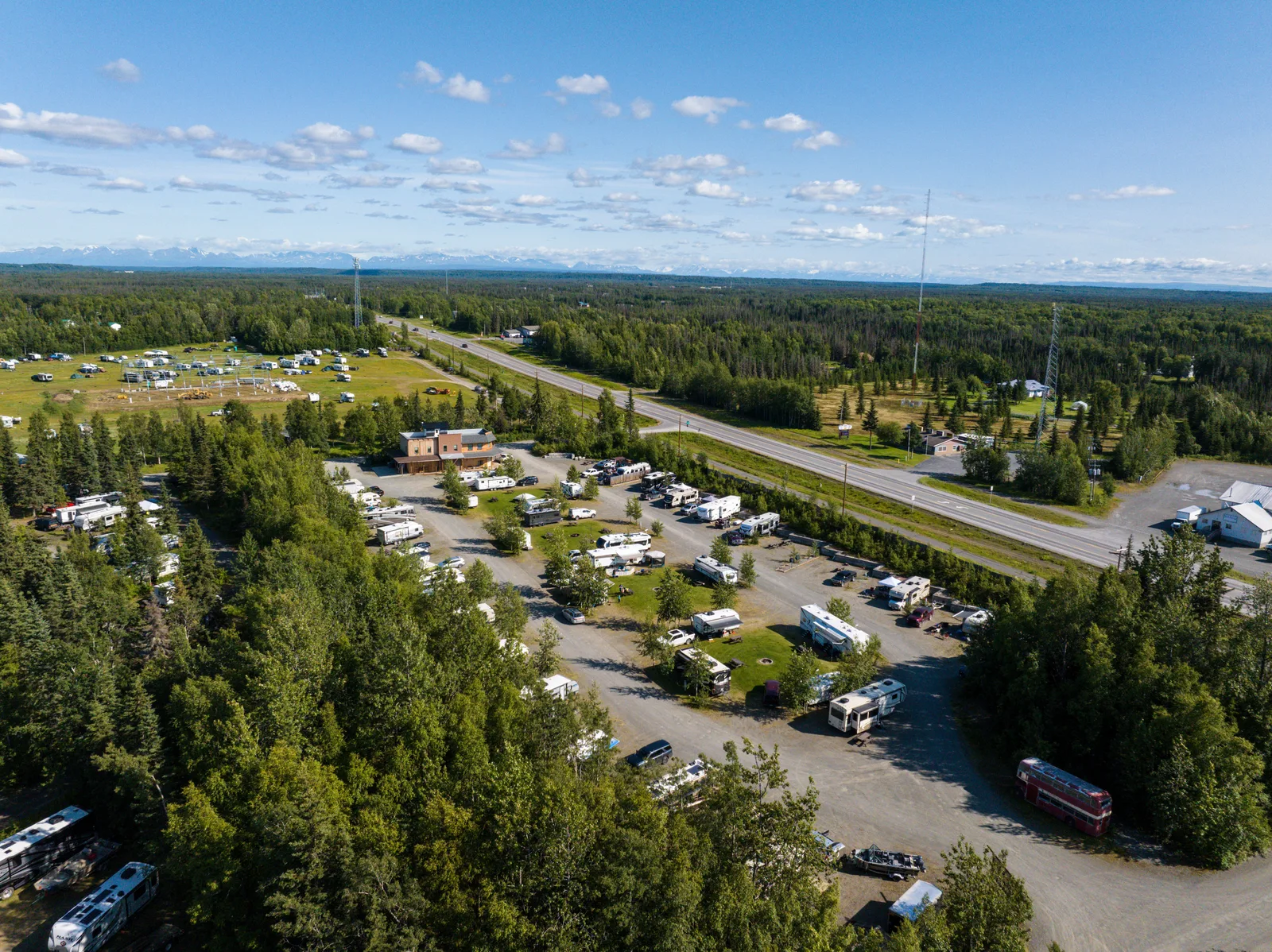 High-altitude drone aerial view of Diamond M Ranch Resort RV loops and spruce tree line