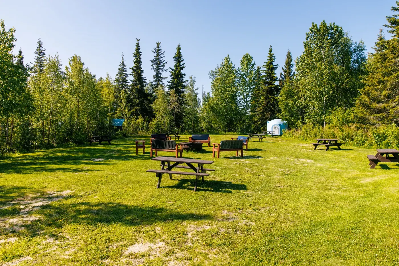 Panoramic view from Tent Hill over green pastures toward Alaskan mountains